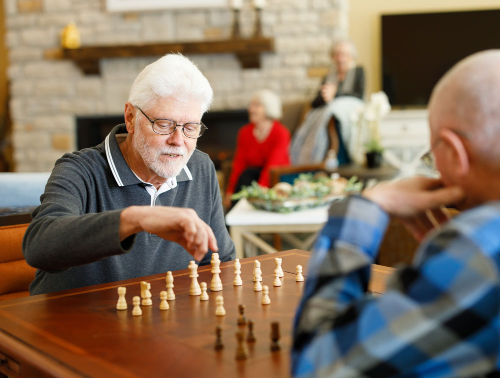 Two men playing games in the common room