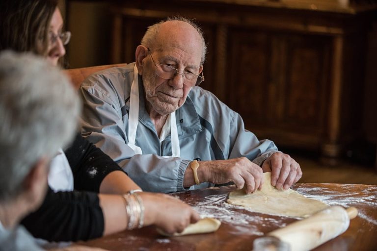 Staff and residents making pie dough