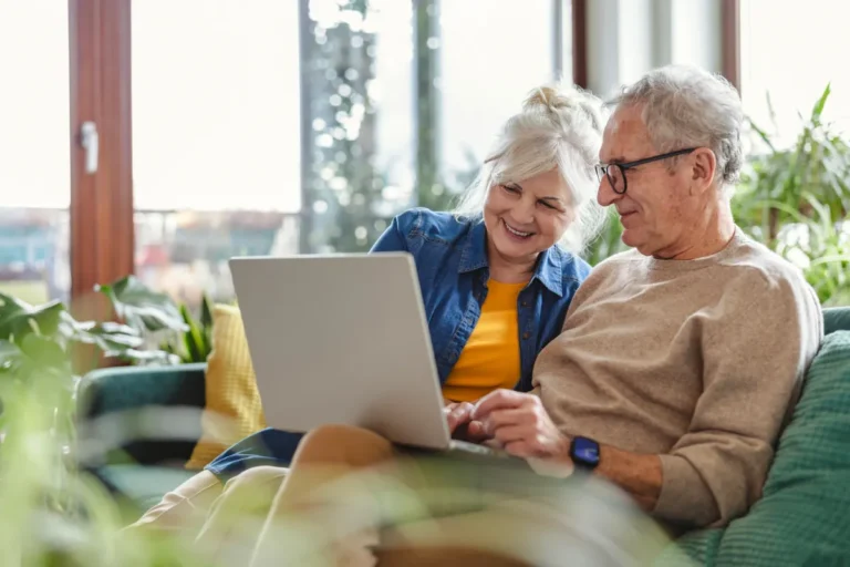 Senior couple looking at laptop