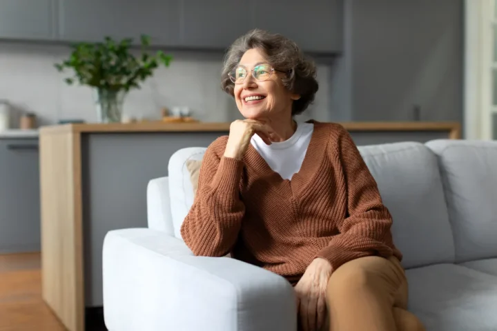 Senior woman sitting in assisted living apartment Senior woman sitting in assisted living apartment